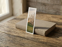 A New Life fine art bookmark resting on a linen-bound book in soft window light