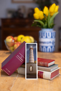 Alone in the Dark fine art bookmark beside a stack of vintage books