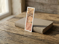 Autumn Cottage fine art bookmark resting on a linen-bound book in soft window light