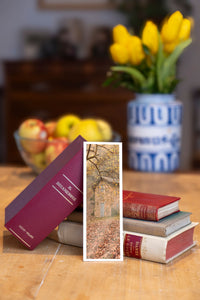 Autumn Cottage fine art bookmark beside a stack of vintage books