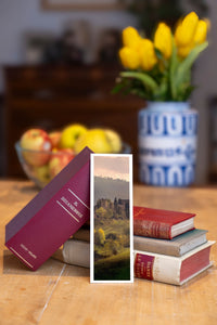Autumn Hills fine art bookmark beside a stack of vintage books