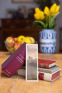 Autumn Solitude fine art bookmark beside a stack of vintage books