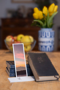 Bali Sunset fine art bookmark styled with a dark book and fresh fruit