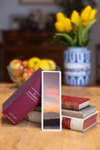 Bali Sunset fine art bookmark beside a stack of vintage books