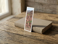 Burnt Mountain fine art bookmark resting on a linen-bound book in soft window light
