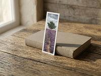 Careful Sentry fine art bookmark resting on a linen-bound book in soft window light
