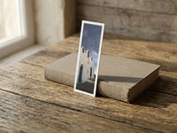 Chapel Light fine art bookmark resting on a linen-bound book in soft window light