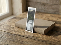Cliff Waves fine art bookmark resting on a linen-bound book in soft window light