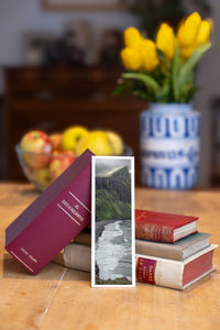 Cliff Waves fine art bookmark beside a stack of vintage books