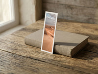Copper Dunes fine art bookmark resting on a linen-bound book in soft window light