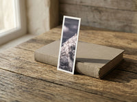 Crystal Peak fine art bookmark resting on a linen-bound book in soft window light