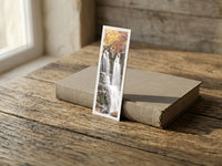 Dardagna Waterfall fine art bookmark resting on a linen-bound book in soft window light