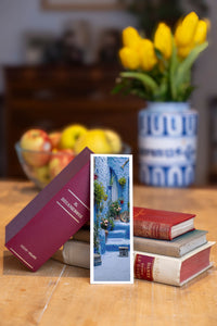 Deep Blue fine art bookmark beside a stack of vintage books