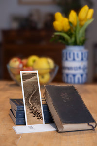 Desert Footprints fine art bookmark styled with a dark book and fresh fruit