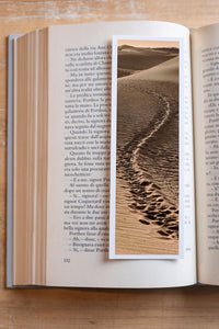 Desert Footprints fine art bookmark resting in an open book, close-up