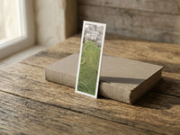 Dragon's Backbone fine art bookmark resting on a linen-bound book in soft window light