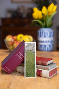 Dragon's Backbone fine art bookmark beside a stack of vintage books