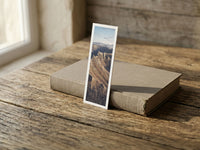 Dragon's Teeth fine art bookmark resting on a linen-bound book in soft window light