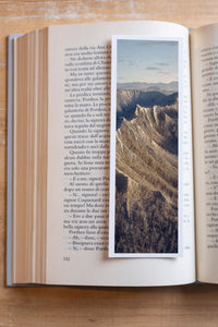 Dragon's Teeth fine art bookmark resting in an open book, close-up