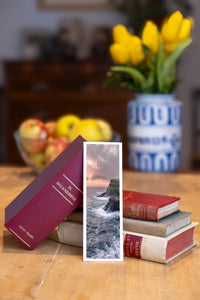 Edge of the World fine art bookmark beside a stack of vintage books