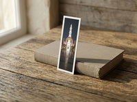 Enlightened Minaret fine art bookmark resting on a linen-bound book in soft window light