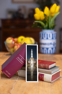 Enlightened Minaret fine art bookmark beside a stack of vintage books