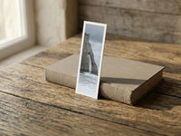 Etretat Arch fine art bookmark resting on a linen-bound book in soft window light
