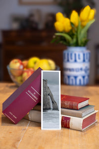 Etretat Arch fine art bookmark beside a stack of vintage books