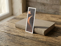 Fire Tongue fine art bookmark resting on a linen-bound book in soft window light