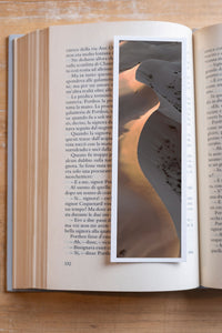 Fire Tongue fine art bookmark resting in an open book, close-up