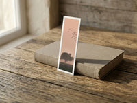 Forest Flight fine art bookmark resting on a linen-bound book in soft window light