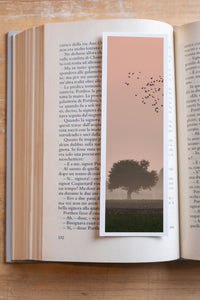 Forest Flight fine art bookmark resting in an open book, close-up