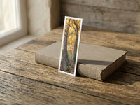 Forest Gates fine art bookmark resting on a linen-bound book in soft window light