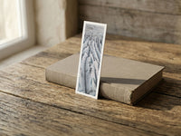 Frozen Veins fine art bookmark resting on a linen-bound book in soft window light