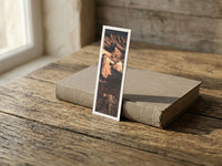 Golden Ridges fine art bookmark resting on a linen-bound book in soft window light