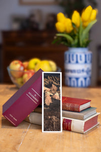 Golden Ridges fine art bookmark beside a stack of vintage books