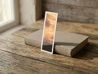 Golden Rise fine art bookmark resting on a linen-bound book in soft window light