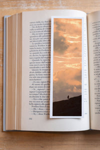 Golden Rise fine art bookmark resting in an open book, close-up