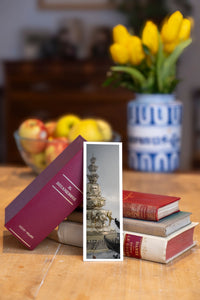 Golden Summit fine art bookmark beside a stack of vintage books