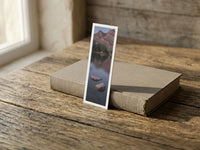 Hidden Oasis fine art bookmark resting on a linen-bound book in soft window light
