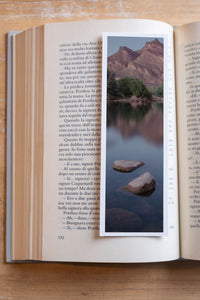 Hidden Oasis fine art bookmark resting in an open book, close-up
