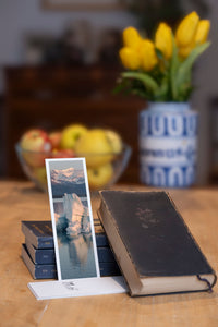 Icy Sunrise fine art bookmark styled with a dark book and fresh fruit