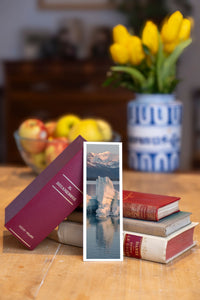 Icy Sunrise fine art bookmark beside a stack of vintage books
