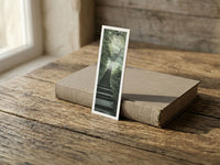 Jungle Stairway fine art bookmark resting on a linen-bound book in soft window light