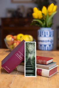 Jungle Stairway fine art bookmark beside a stack of vintage books