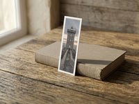 Kermorvan fine art bookmark resting on a linen-bound book in soft window light