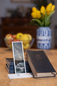 Land's End fine art bookmark styled with a dark book and fresh fruit