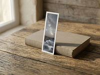 Land's End fine art bookmark resting on a linen-bound book in soft window light