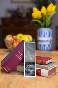 Land's End fine art bookmark beside a stack of vintage books
