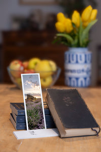 Lavender Farmer fine art bookmark styled with a dark book and fresh fruit